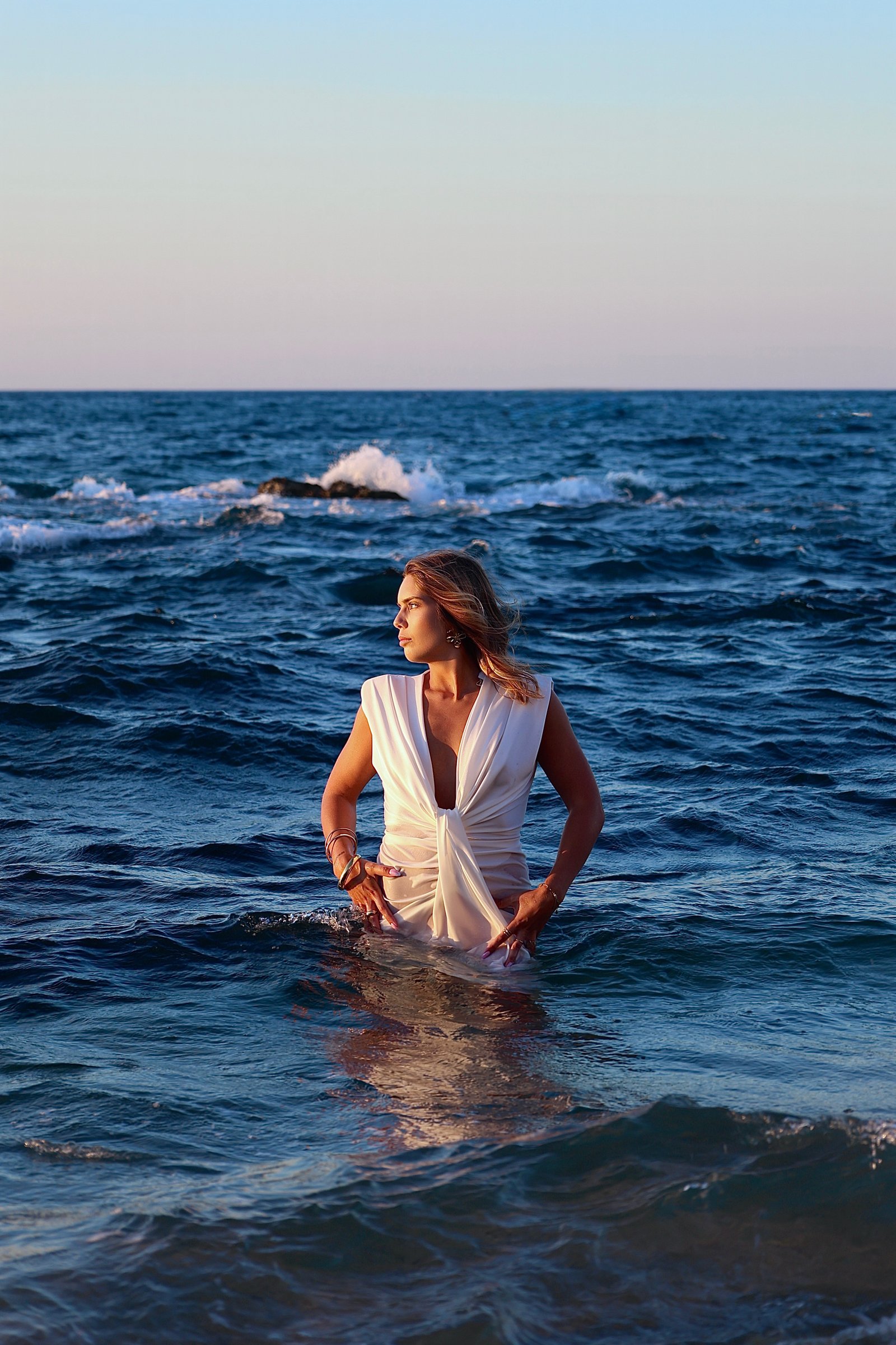 jeune femme au milieu de l'eau en robe blanche 